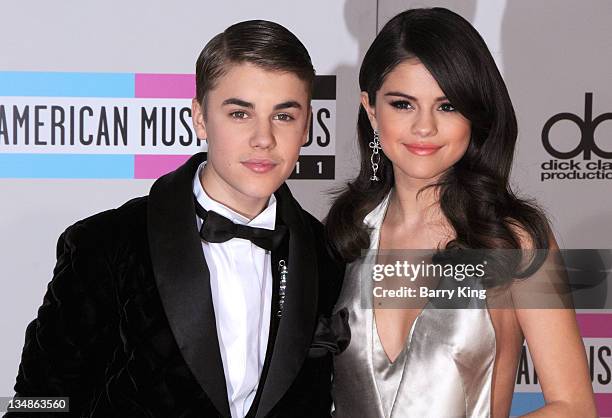 Singer Justin Bieber and singer/actress Selena Gomez arrive at the 2011 American Music Awards held at Nokia Theatre L.A. Live on November 20, 2011 in...