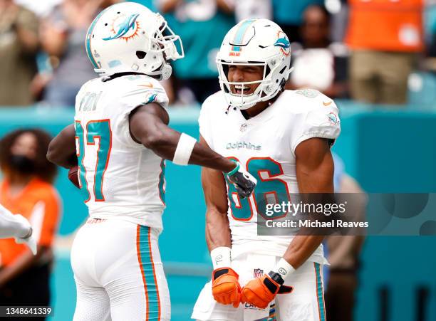 Isaiah Ford of the Miami Dolphins celebrates with Mack Hollins after a touchdown catch during the first quarter against the Atlanta Falcons in the...