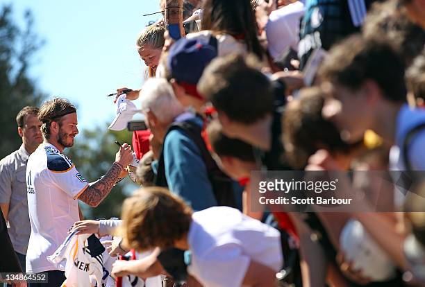 David Beckham of the Galaxy signs autographs for supporters after an LA Galaxy training session at Visy Park on December 5, 2011 in Melbourne,...