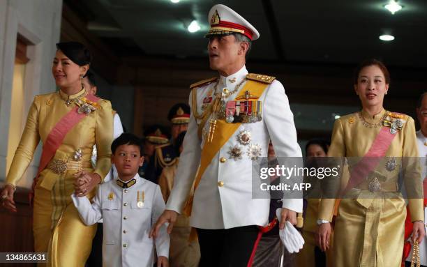 Princess Srirasm, Prince Dipangkorn Rasmijoti, Thai Crown Prince Maha Vajiralongkorn and Princess Bajrakitiyabha walk behind Thailand's King Bhumibol...