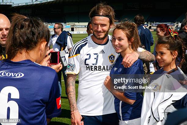 David Beckham of the Galaxy poses poses for a photograph with supporters during an LA Galaxy training session at Visy Park on December 5, 2011 in...