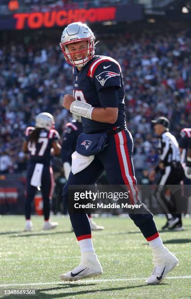 Mac Jones of the New England Patriots celebrates after throwing for a touchdown during the second quarter in the game against the New York Jets at...