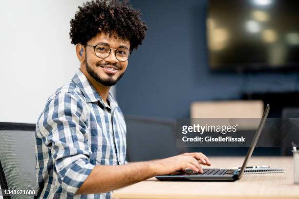 porträt eines hörgeschädigten mannes, der im büro arbeitet - taub stock-fotos und bilder