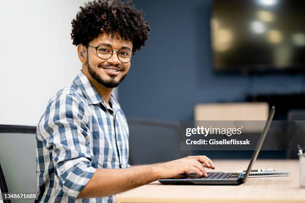 portrait of a hearing impaired man working in office - deafness stock pictures, royalty-free photos & images