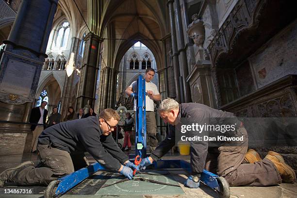 Stonemasons lay a new memorial to Poet Laureate Ted Hughes in Poets' Corner inside Westminster Abbey on December 2, 2011 in London, England. The...