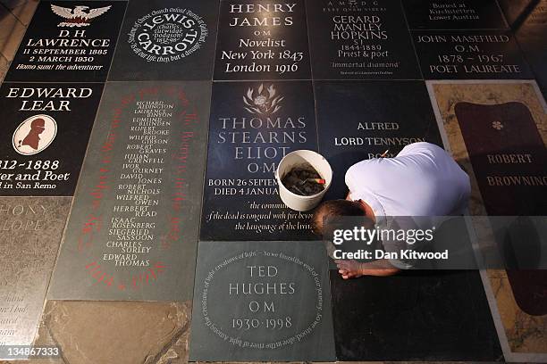 Stonemason puts the finishing touches to a new memorial to Poet Laureate Ted Hughes in Poets' Corner inside Westminster Abbey on December 2, 2011 in...