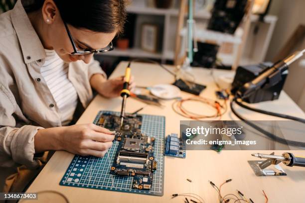 female engineer repairing computer - soldered stock pictures, royalty-free photos & images