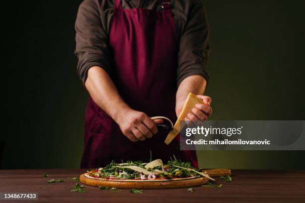 fresh parmesan to finish the best dish - deep dish pizza stock pictures, royalty-free photos & images
