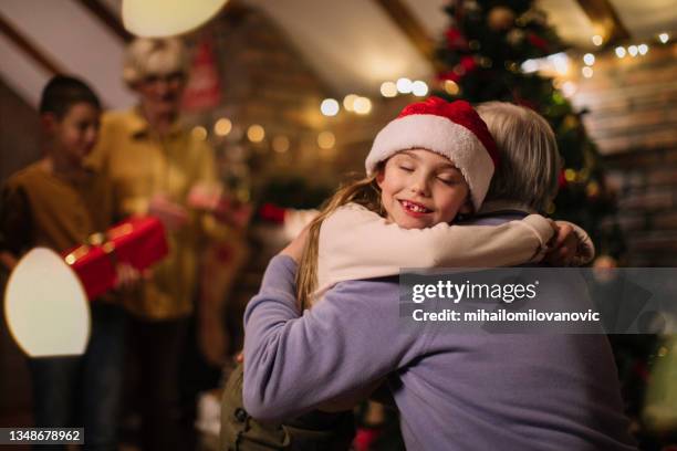 these hugs are something he will remember - hug christmas stock pictures, royalty-free photos & images