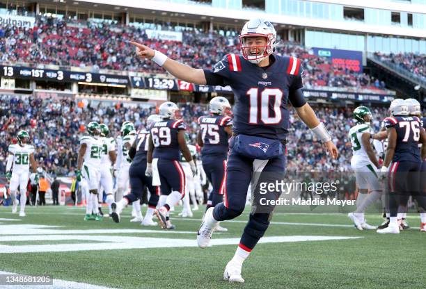 Mac Jones of the New England Patriots celebrates after a touchdown \f in the game at Gillette Stadium on October 24, 2021 in Foxborough,...