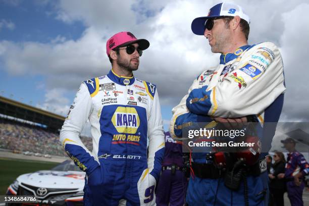 Chase Elliott, driver of the NAPA Auto Parts Chevrolet, and crew chief Alan Gustafson talk on the grid prior to the NASCAR Cup Series Hollywood...