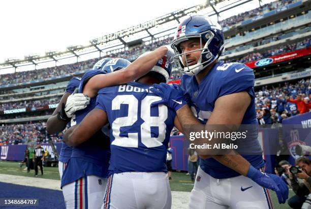 Devontae Booker of the New York Giants celebrates a touchdown with teammates during the second half in the game against the Carolina Panthers at...