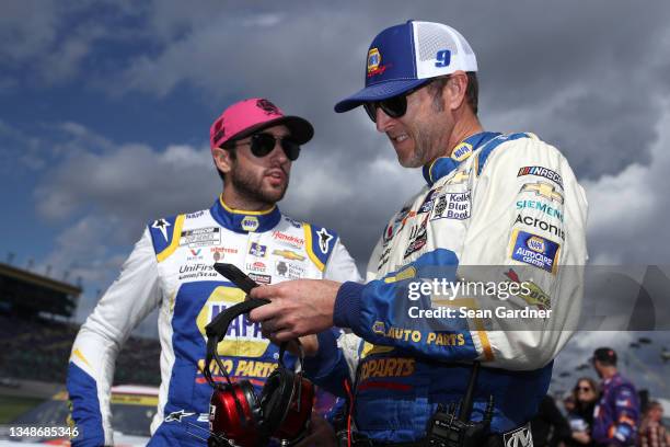 Chase Elliott, driver of the NAPA Auto Parts Chevrolet, and crew chief Alan Gustafson talk on the grid prior to the NASCAR Cup Series Hollywood...