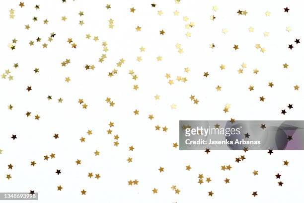 golden confetti on white background - coriandoli foto e immagini stock