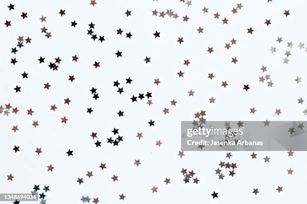 silver  star confetti on white background - silverstars stock pictures, royalty-free photos & images