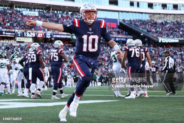 Mac Jones of the New England Patriots celebrates a touchdown in the second half against the New York Jets at Gillette Stadium on October 24, 2021 in...