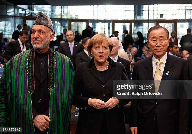 Afghan President Hamid Karzai, German Chancellor Angela Merkel and UN Secretary-General Ban Ki Moon arrive at the 10th annual international...