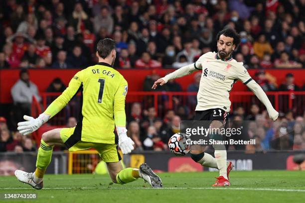 Mohamed Salah of Liverpool shoots past Manchester United goalkeeper David De Gea to score his hat trick during the Premier League match between...