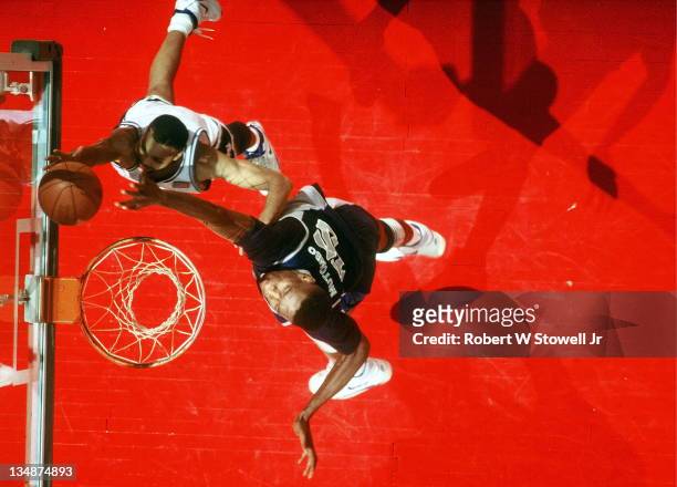 Georgetown's Dikembe Mutombo contests a shot by UConn's Chris Smith, Hartford CT 1990.