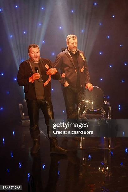 Philippe Starck poses next to his wax figure at Musee Grevin on June 15, 2010 in Paris, France.