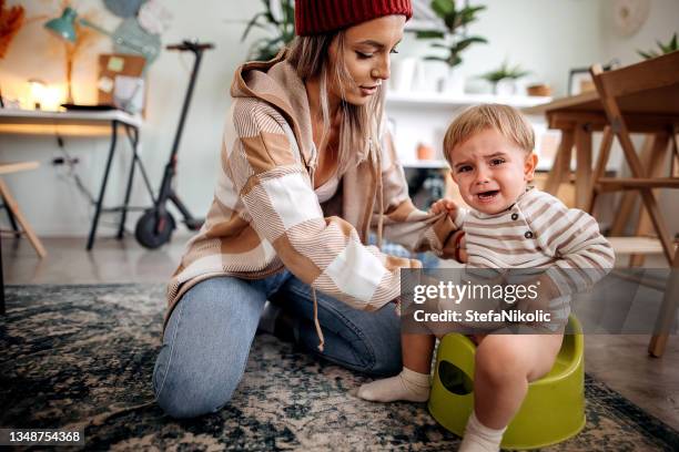 mother training her son to use potty s - exkrement bildbanksfoton och bilder