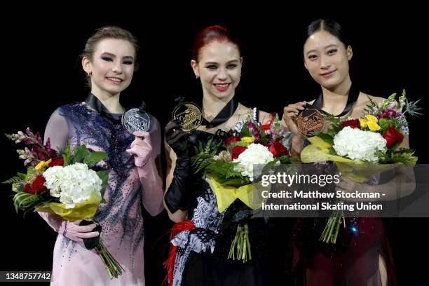 Daria Usacheva of Russia, Alexandra Trusova of Russia and Young You of South Korea pose on the medal podium after skating in the Women's Competition...