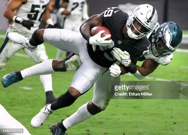Bryan Edwards of the Las Vegas Raiders is tackled by linebacker Davion Taylor of the Philadelphia Eagles after a 24-yard pass play during their game...