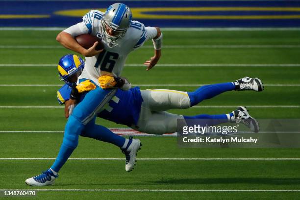 Jared Goff of the Detroit Lions is tacked by Kenny Young of the Los Angeles Rams during the second half in the game at SoFi Stadium on October 24,...