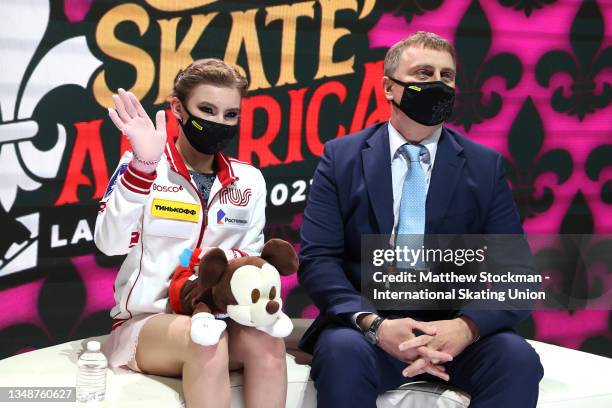 Daria Usacheva of Russia celebrates in the Kiss & Cry with her coach Valery Artyukhov after skating in the Women's Free Skate during the ISU Grand...