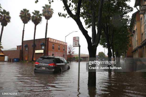 Minivan sits stranded on a flooded street on October 24, 2021 in San Rafael, California. A Category 5 atmospheric river is bringing heavy...