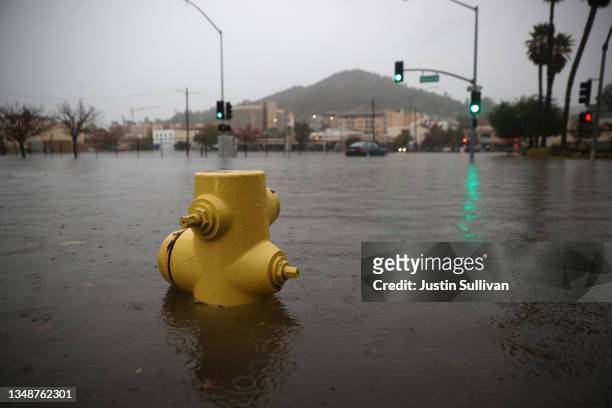 Fire hydrant is almost fully submerged on a flooded street on October 24, 2021 in San Rafael, California. A Category 5 atmospheric river is bringing...