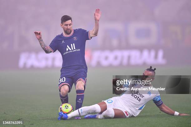 Leo Messi of Paris Saint-Germain is tackled by Dimitri Payet of Olympique de Marseille during the Ligue 1 Uber Eats match between Marseille and Paris...