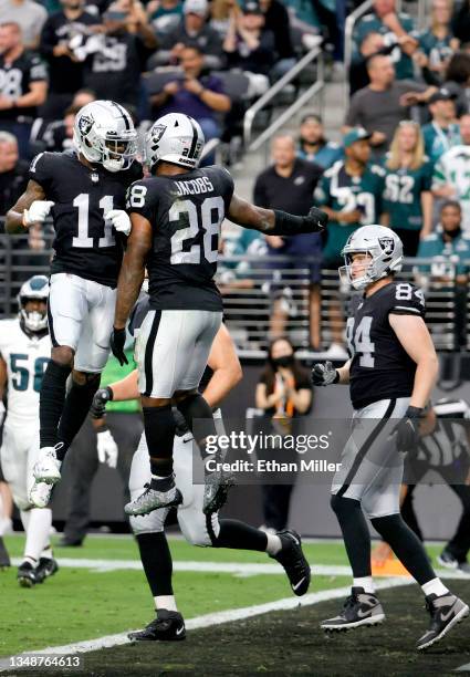 Josh Jacobs of the Las Vegas Raiders celebrates a touchdown with Henry Ruggs III during the first half in the game against the Philadelphia Eagles at...