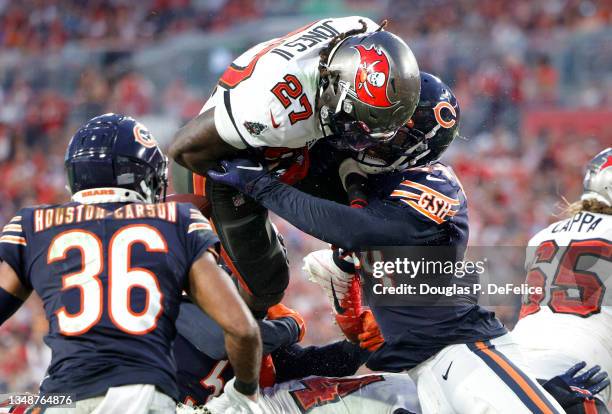 Ronald Jones II of the Tampa Bay Buccaneers runs with the ball while being tackled by Alec Ogletree of the Chicago Bears in the fourth quarter in the...