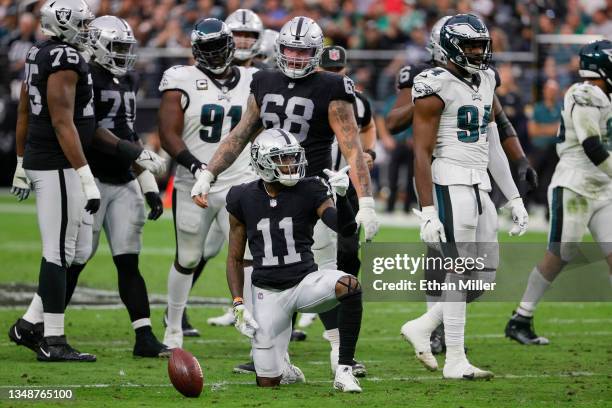 Henry Ruggs III of the Las Vegas Raiders spins the ball on the ground and gestures as he celebrates a catch for a first down during the first half in...