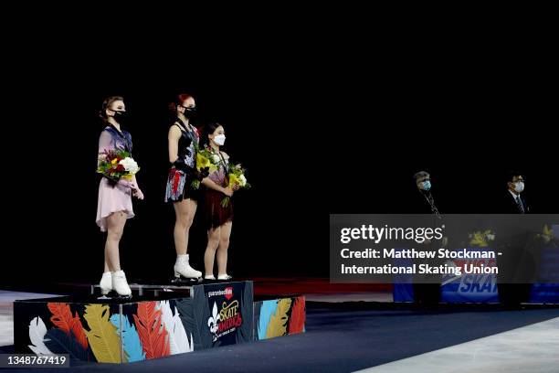 Daria Usacheva of Russia, Alexandra Trusova of Russia and Young You of South Koreastand for the Russian National Anthem on the medal podium after...