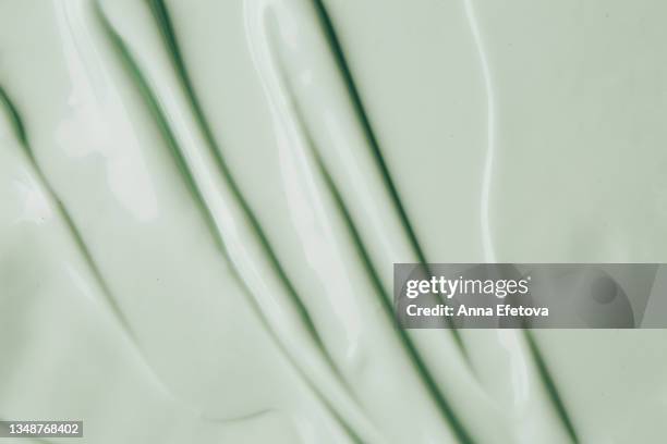 background made of textured smears of green cream. flat lay style - conditioner stock pictures, royalty-free photos & images