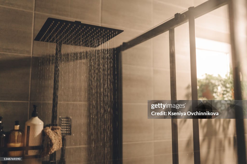 Close up of Water flowing from shower in the bathroom interior