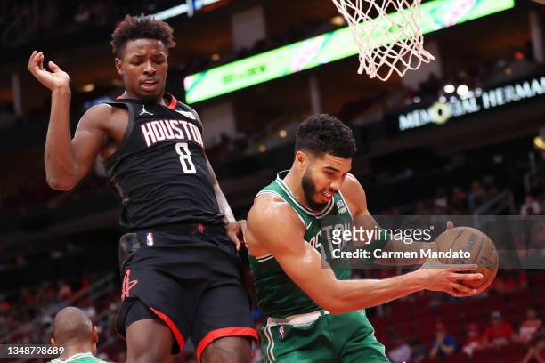Jayson Tatum of the Boston Celtics grabs a rebound ahead of Jae'Sean Tate of the Houston Rockets during the second half at Toyota Center on October...