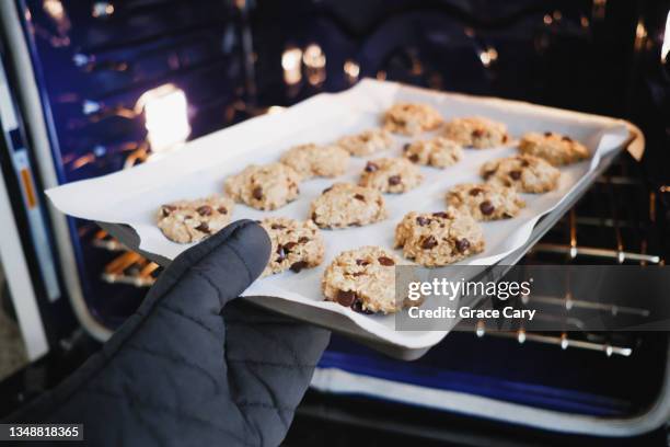 woman prepares to bake vegan oatmeal chocolate chip cookies - chocolate chip stock pictures, royalty-free photos & images