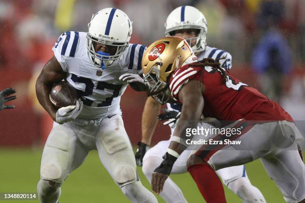 Xavier Rhodes of the Indianapolis Colts tries to get around the tackle of JaMycal Hasty of the San Francisco 49ers during the second half at Levi's...