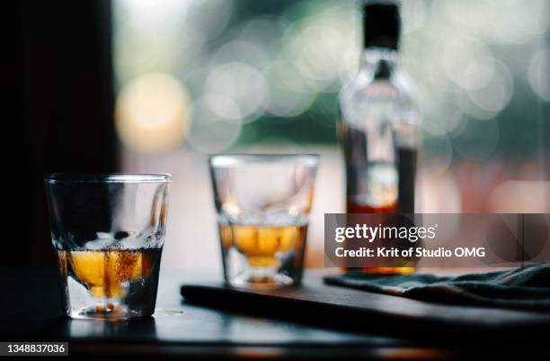 the glass of and bottle of wishy on the table - liqueur stock pictures, royalty-free photos & images