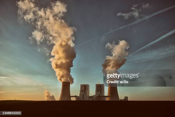 toned photograph of a coal fired power plant with pollution - ozone layer stock pictures, royalty-free photos & images