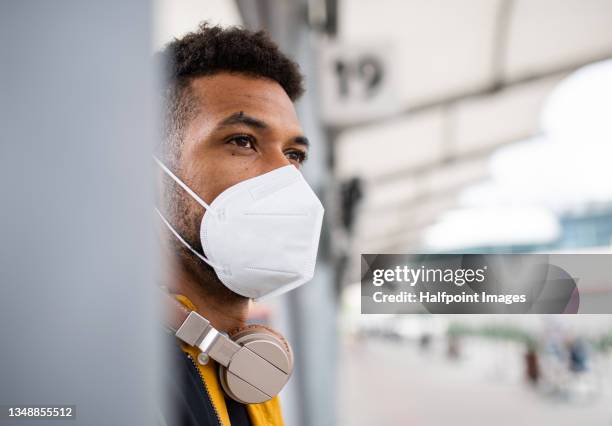 close up of man commuter at the bus station with face mask, coronavirus concept. - mask man stock pictures, royalty-free photos & images