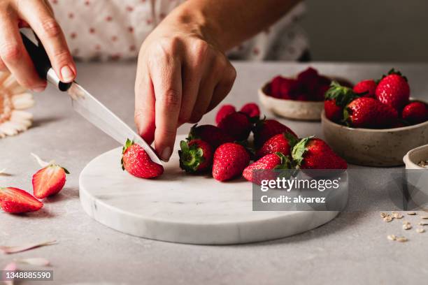 female hands cutting strawberries - berries and hand stock pictures, royalty-free photos & images