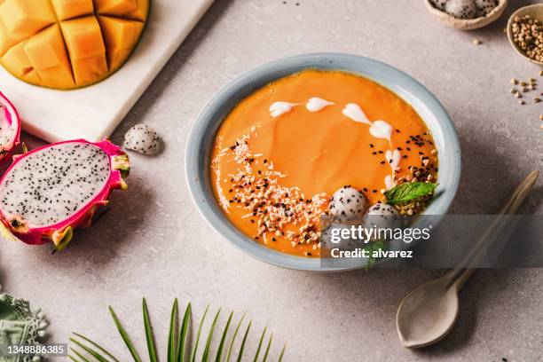 mango and dragon fruit smoothie bowl on the kitchen counter - mango smoothie stock pictures, royalty-free photos & images