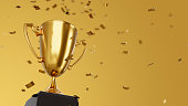 Golden winner cup and confetti