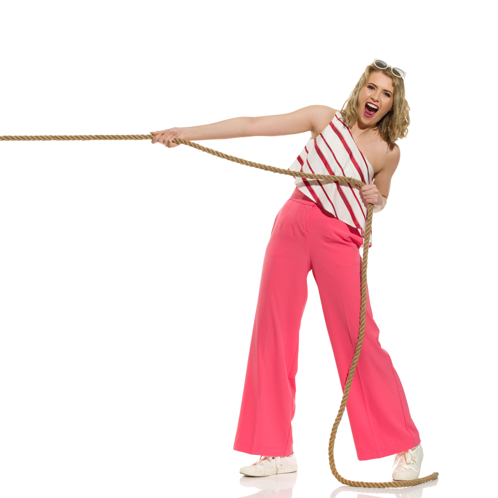 Excited young woman is pulling the rope and shouting. Full length isolated. Excited young woman is pulling the rope and shouting. Full length isolated.
