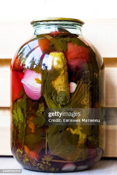 pickled and salted mixed vegetables cucumbers and tomatoes in big glass jar. healthy organic food - home salted stock pictures, royalty-free photos & images