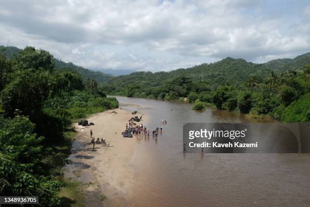 Tourists enjoy themselves on the banks of Rio Don Diego on August 9, 2021 in Santa Marta, Colombia.